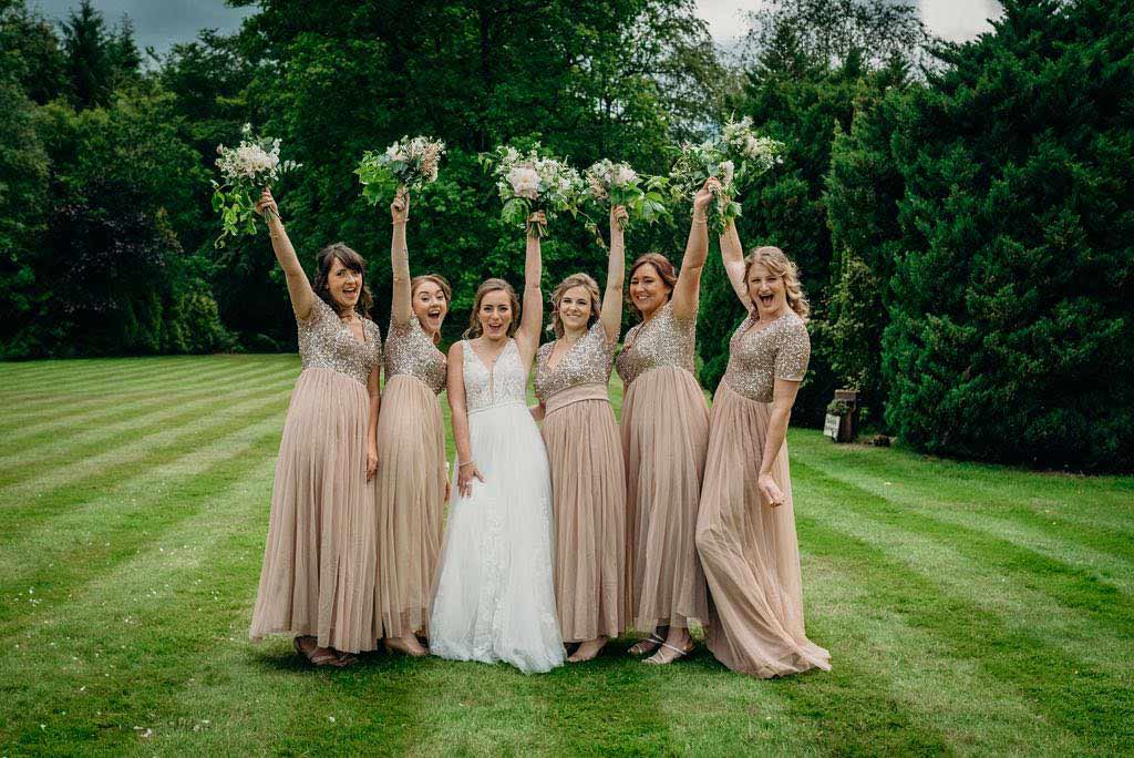 bride and bridesmaids holding up bouquets