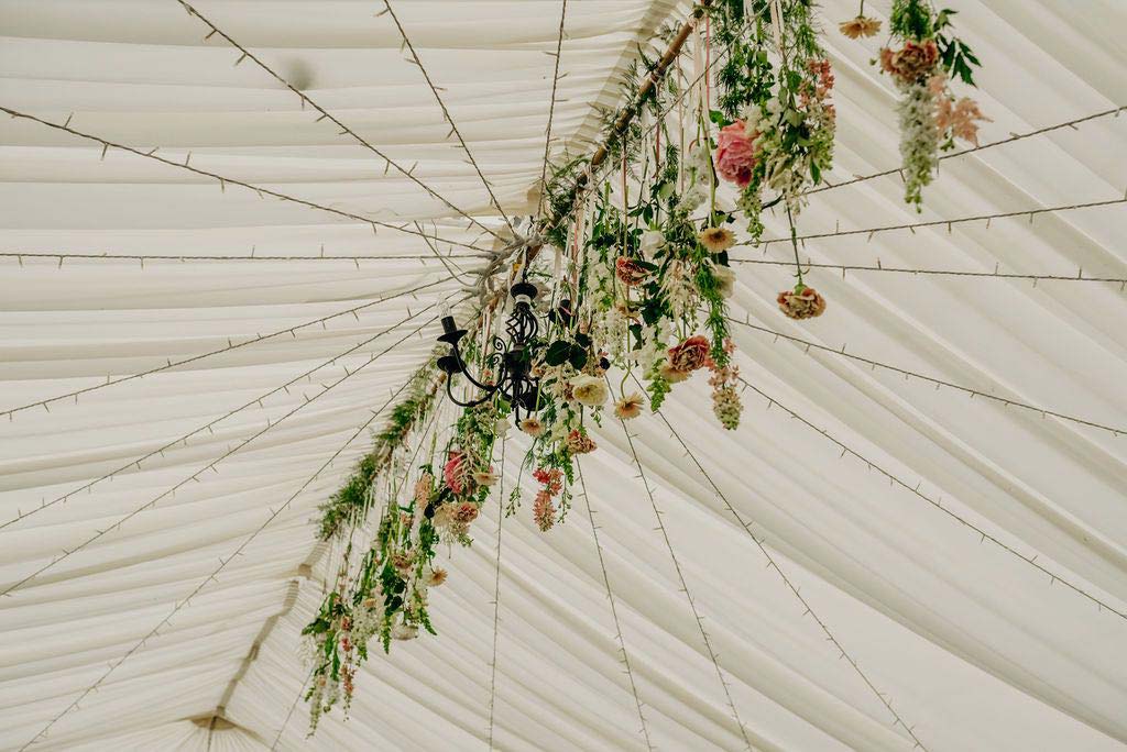 Wedding flowers decorating the marquee roof