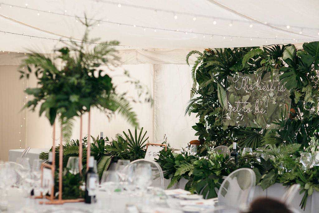 Green foliage decorating wedding marquee