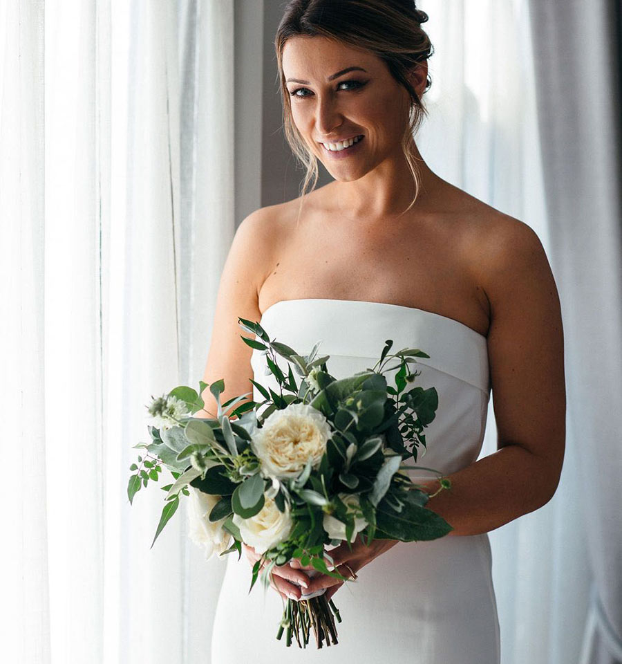 Bride holding green and white bouquet