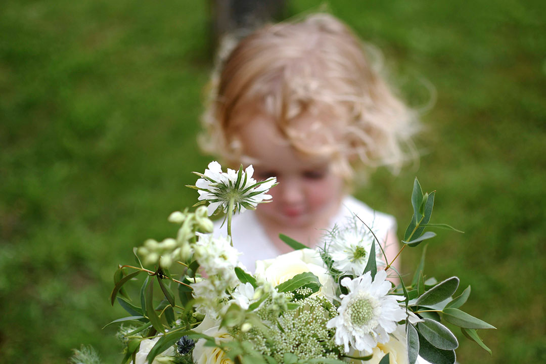 Little bridesmaid holding bouquet